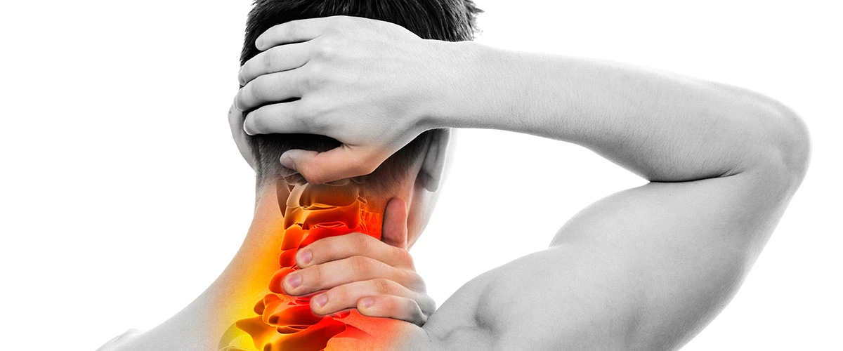 Person experiencing chronic neck pain while consulting with a healthcare provider about treatment options.

